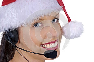 Closeup of attractive female call center telephonist wearing Christmas Santa hat, isolated on white
