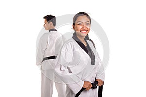 Closeup of attractive female fighter smiles, her male partner on the back