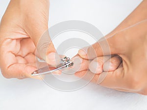 Closeup attractive young woman cutting her feet nails.