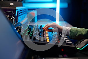 Closeup audio engineer hand on sound mixer control panel