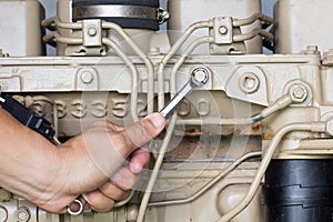 Closeup of an auto mechanic working on a Generator power