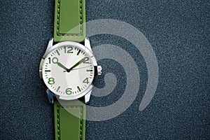 Closeup automatic men watch with green wrist on dark background