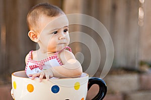 Closeup of baby girl in giant teacup