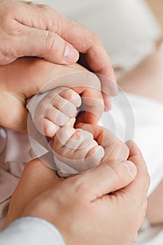 Closeup of baby hand into parents hands. Family concept