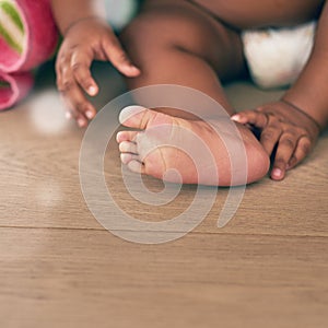 Closeup of baby, kids and feet with toes on wooden floor, home or nursery room mockup. Young infant children, foot and