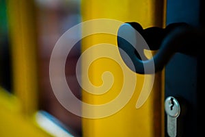 Closeup of a back door handle and key lock.