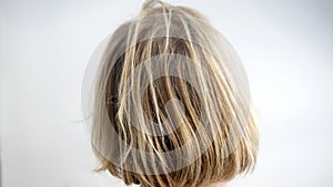 Closeup of back of head with uncombed blond hair