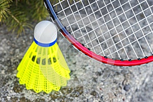 Closeup of badminton rachet and neon yellow shuttlecock, sports