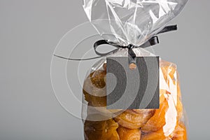 Closeup on bag of dried apricots with black blank label