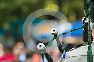 Closeup Of Bagpipes Resting Against Shoulder As Man Plays Instrument