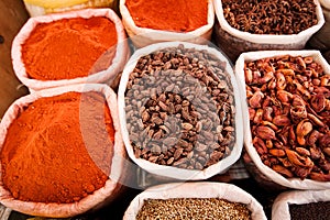 Closeup of bags with colored spices on the market in Goa, India