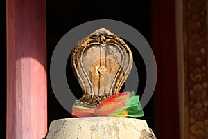 Closeup of Bai Sema or Sacred Boundary Stone in front of the Old Ordination Hall of Wat Chomphuwek Buddhist Temple in Thailand
