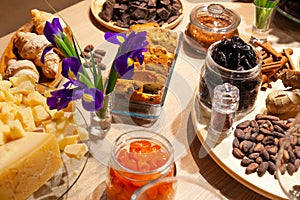 Closeup bakery and snacks, dried fruits, pieces parmesan cheese, flowers, nuts, cinnamon sticks, raisin biscotti. Concept