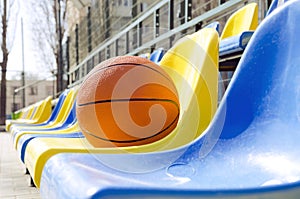 Closeup of ball on the school stadium seats.Concept of basketball competition at the local sport court
