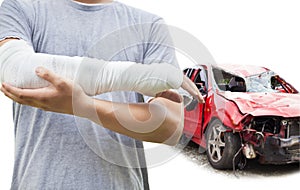 Closeup of bandaged arm with blue wrecked car