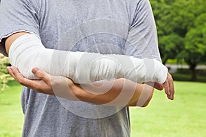 Closeup of bandaged arm with park background photo