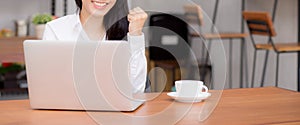Closeup banner website asian young businesswoman excited and glad of success with laptop