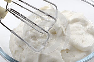 Closeup of beaten egg whites and mixer.Process of preparing ingredients for bakery products