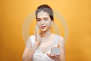 Closeup Of Beautiful Asian Woman With Cushion Puff And Mirror Applying Makeup Powder Foundation