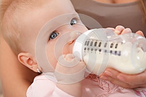 Closeup beautiful baby with nursing bottle