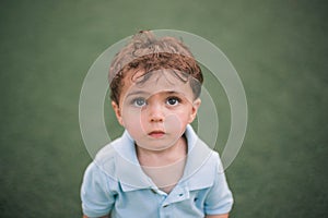 Closeup of a beautiful Caucasian little boy looking ahead with a cute facial expression