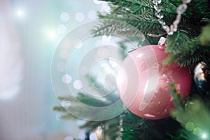 Closeup of beautiful Christmas decorations pink and silver ball hanging on Christmas tree on window background