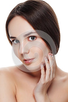Closeup Beautiful face of young woman with clean fresh skin. Portrait woman touch her face by hands with beautiful blue eyes on w