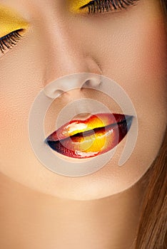 Closeup beautiful female face with colored glossy lips