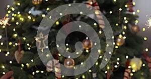 Closeup of beautiful female and man hands holding two stick of holiday sparkler burning isolated at blurry Christmas