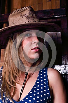 Closeup of beautiful girl with long blond hair wearing hat