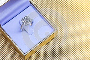 Closeup Beautiful and luxury wedding diamond ring in box on gold background
