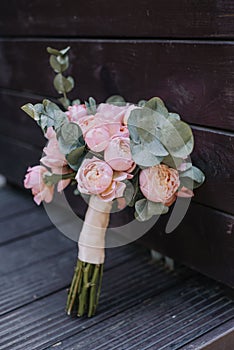 Closeup of beautiful pink rose bouquet held by a gracious bride