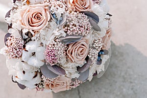 Closeup of beautiful pink rose bouquet held by a gracious bride