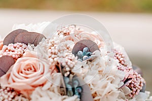 Closeup of beautiful pink rose bouquet held by a gracious bride