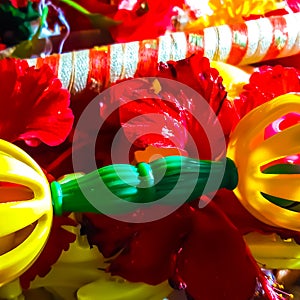 Closeup Beautiful Red Flowers, Attractive Flute And Toys. Happy Krishan Janmashtami Or Happy Radhaashtami.