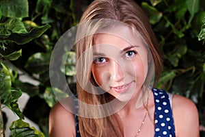 Closeup of beautiful smiling girl with long blond hair