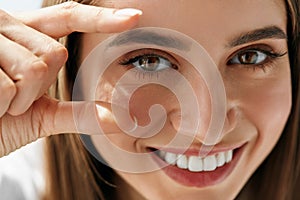 Closeup Of Beautiful Smiling Young Woman With Natural Makeup photo