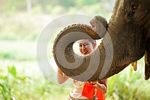 Closeup a beautiful Thai young lady with Thai northern traditional dress acting and play for phot shoot with trunk