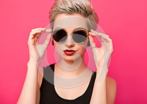 Closeup beautiful trendy hipster girl in retro sunglasses