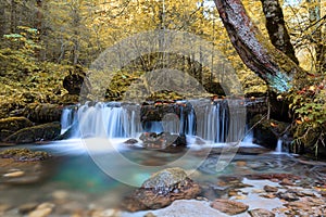 Closeup of beautiful waterfall in autumn season