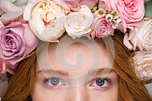 Closeup of beautiful woman eyes in flower wreath