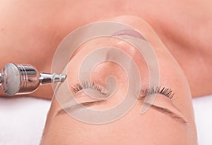 Woman while procedure jet peeling, facial treatmen