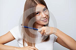 Closeup Of Beautiful Woman Hairbrushing Hair With Brush