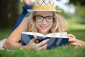closeup beautiful woman reading book at park