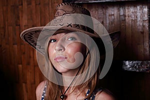 Closeup of beautiful young girl with long blond hair In hat