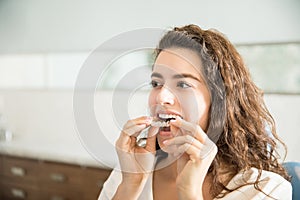 Woman Wearing Clear Aligner In Dental Clinic photo