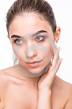 Closeup beauty girl face with natural nude makeup and clean skin isolated on white background. Skincare facial treatment concept.