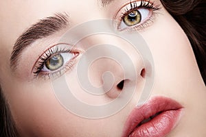 Closeup beauty macro face portrait of young woman. Brunette girl