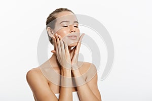 Closeup beauty model girl face with natural nude makeup and clean skin. Skincare facial treatment concept. White