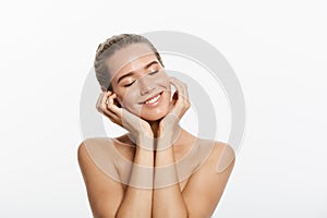 Closeup beauty model girl face with natural nude makeup and clean skin. Skincare facial treatment concept. White